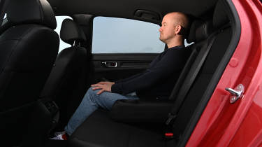 Auto Express chief reviewer Alex Ingram sitting in the Honda Civic's rear seat